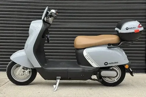 Bicicleta eléctrica Mobulaa con batería extraíble color gris, diseño urbano y asiento beige.